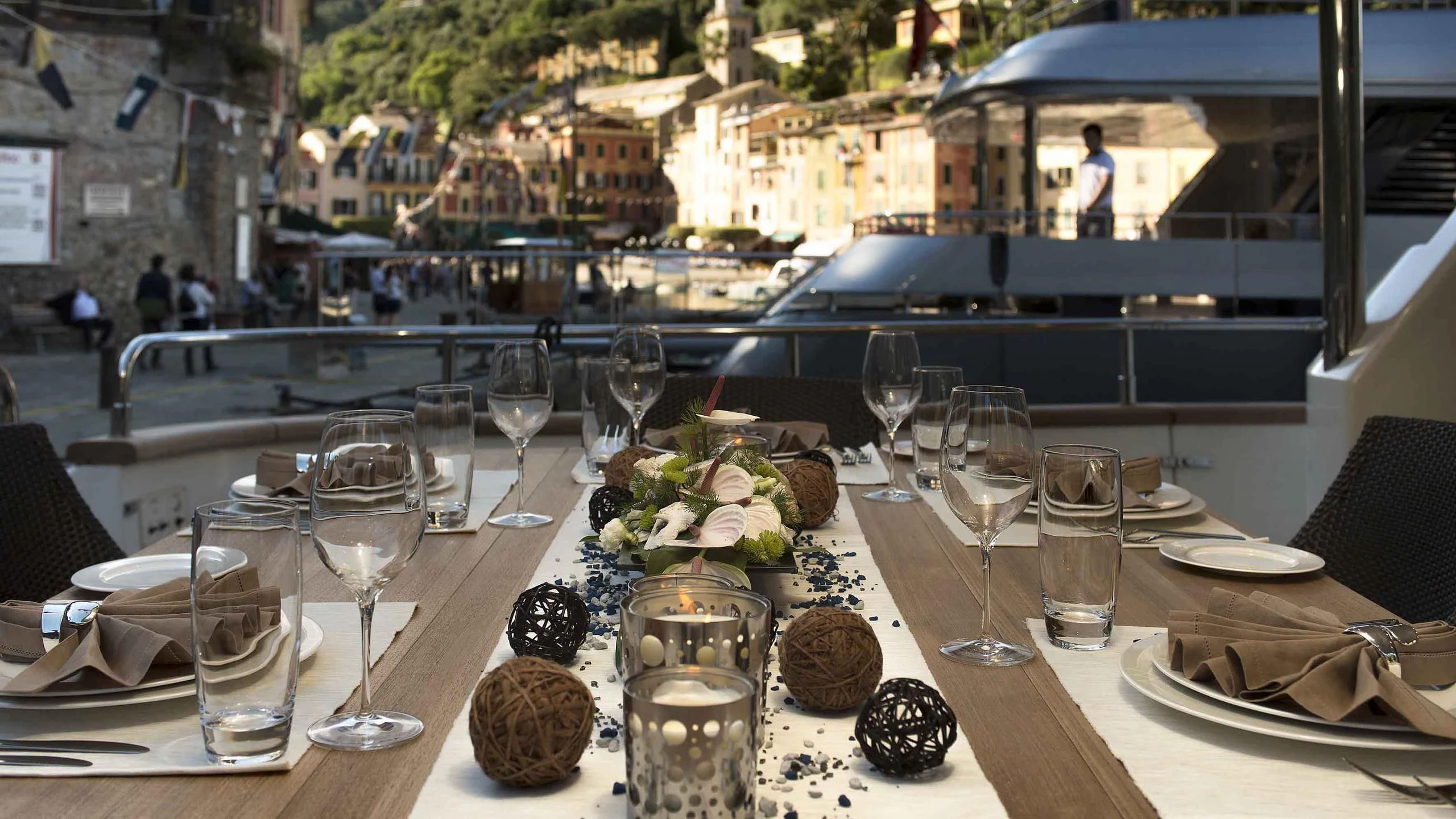 a table with wine glasses and food on it aboard LUMINOUS Yacht for Sale