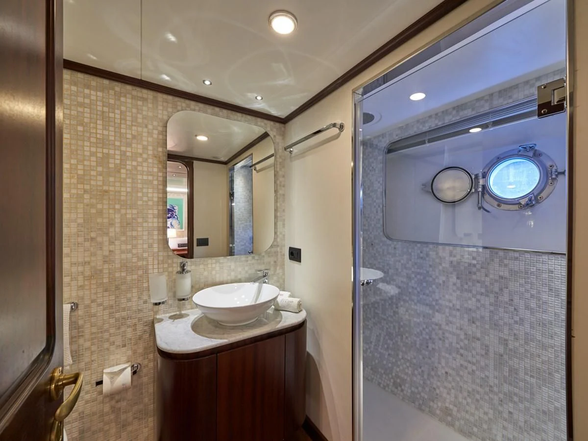 a bathroom with a sink and mirrors aboard DENEB'S DAUGHTERS Yacht for Sale