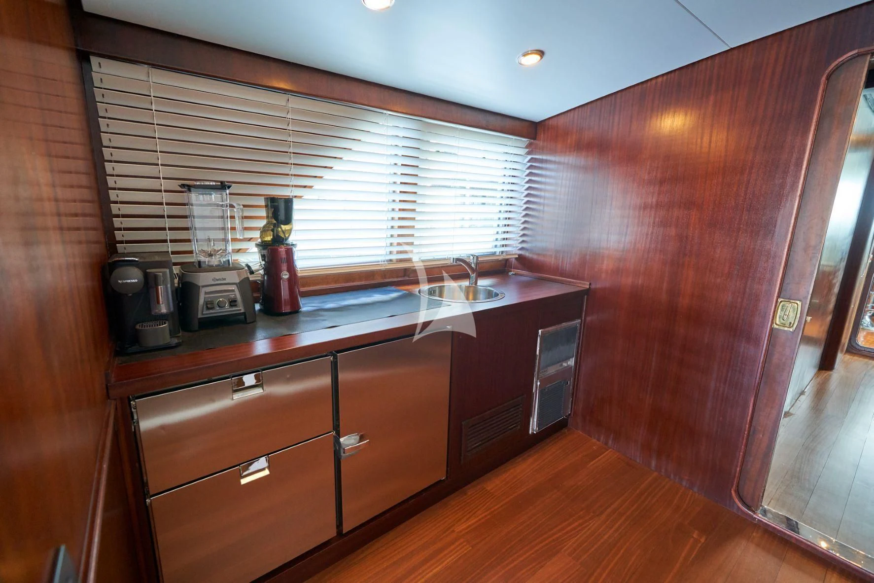 a kitchen with wooden cabinets aboard DENEB'S DAUGHTERS Yacht for Sale