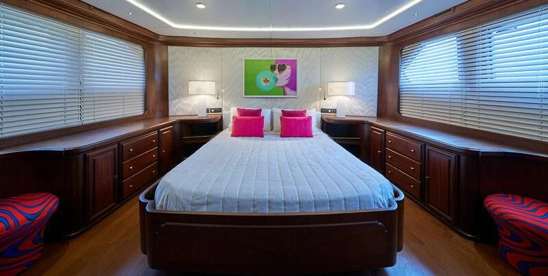 a bedroom with a bed and a desk aboard DENEB'S DAUGHTERS Yacht for Sale