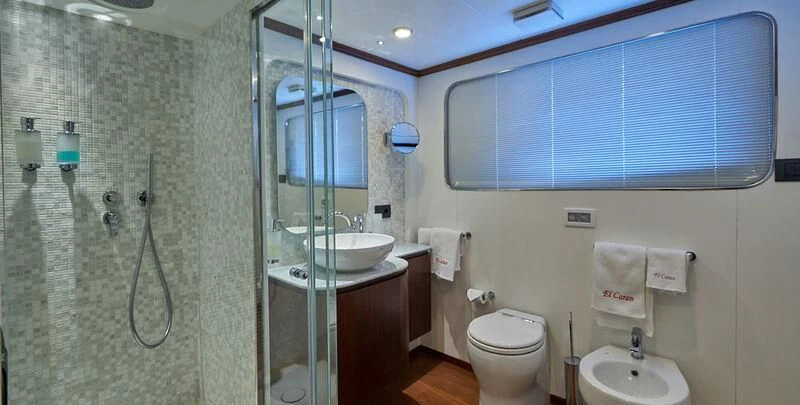 a bathroom with a glass shower aboard DENEB'S DAUGHTERS Yacht for Sale