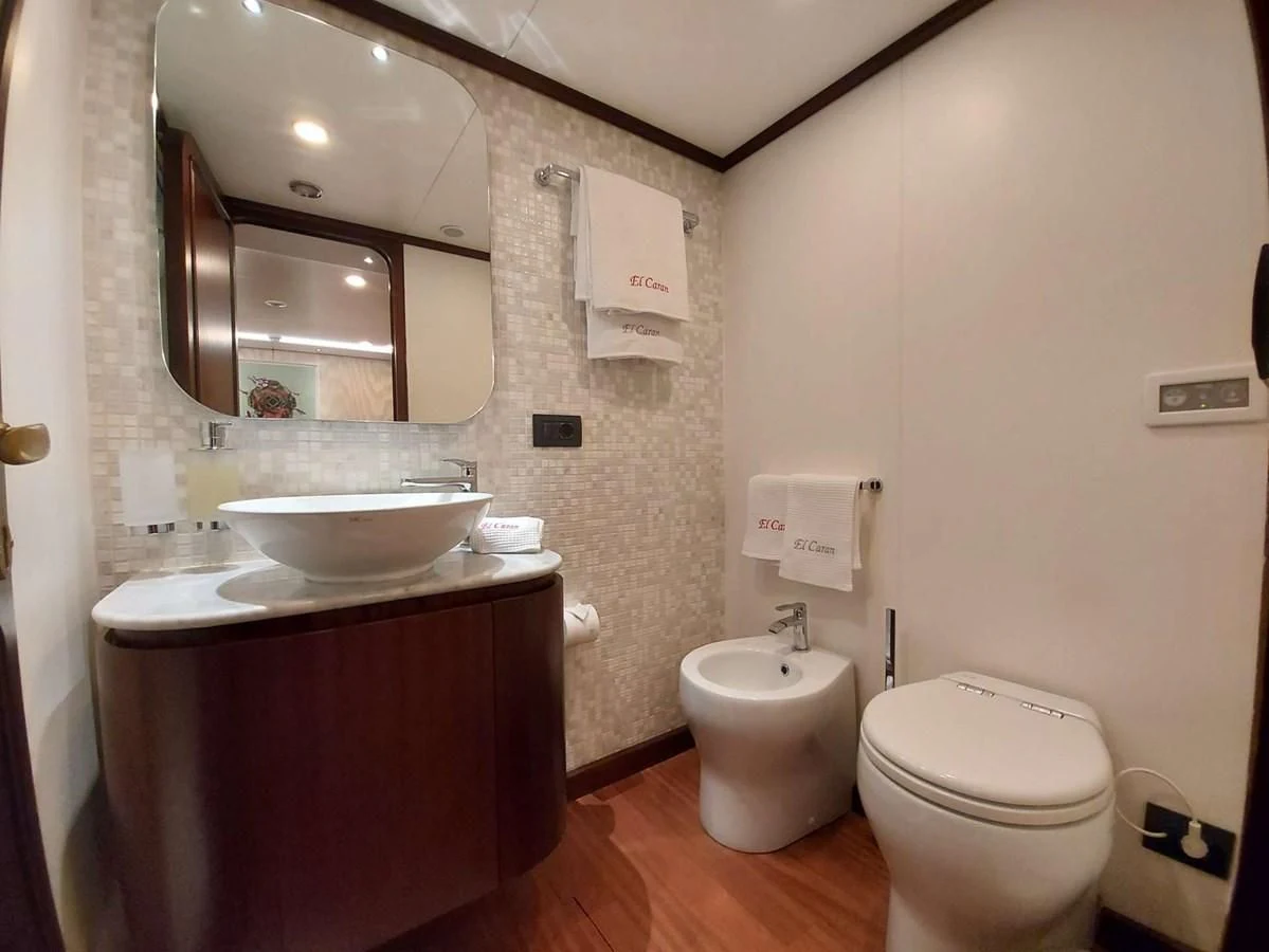 a bathroom with a sink toilet and a mirror aboard DENEB'S DAUGHTERS Yacht for Sale