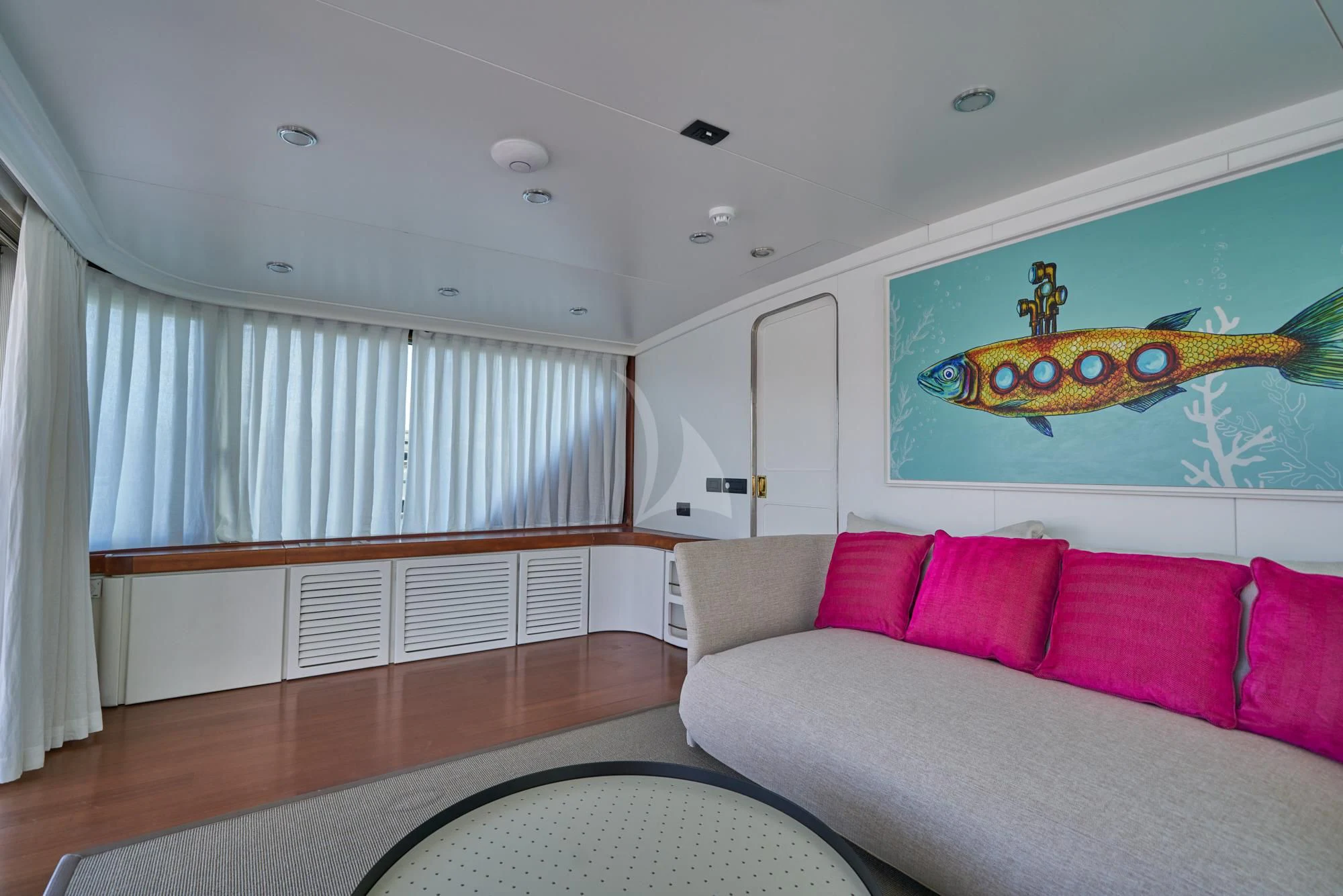 a living room with a couch and a large painting on the wall aboard DENEB'S DAUGHTERS Yacht for Sale