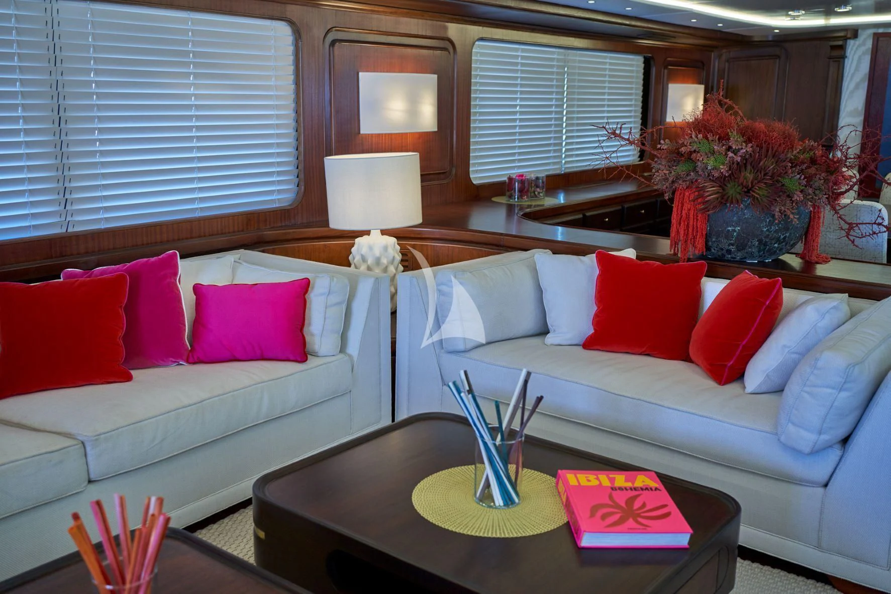 a living room with a white couch and a table with a vase on it aboard DENEB'S DAUGHTERS Yacht for Sale