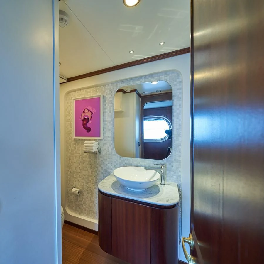a bathroom with a sink and a mirror aboard DENEB'S DAUGHTERS Yacht for Sale