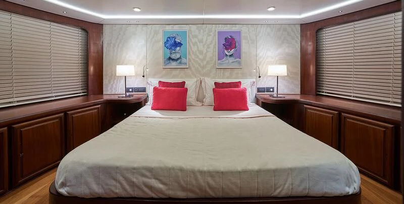 a large bed with red pillows aboard DENEB'S DAUGHTERS Yacht for Sale