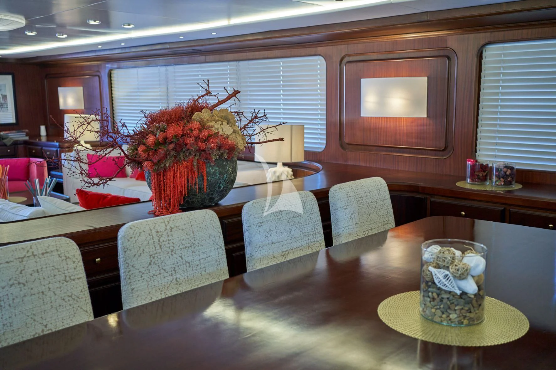 a table with a flower vase and a cup of tea aboard DENEB'S DAUGHTERS Yacht for Sale