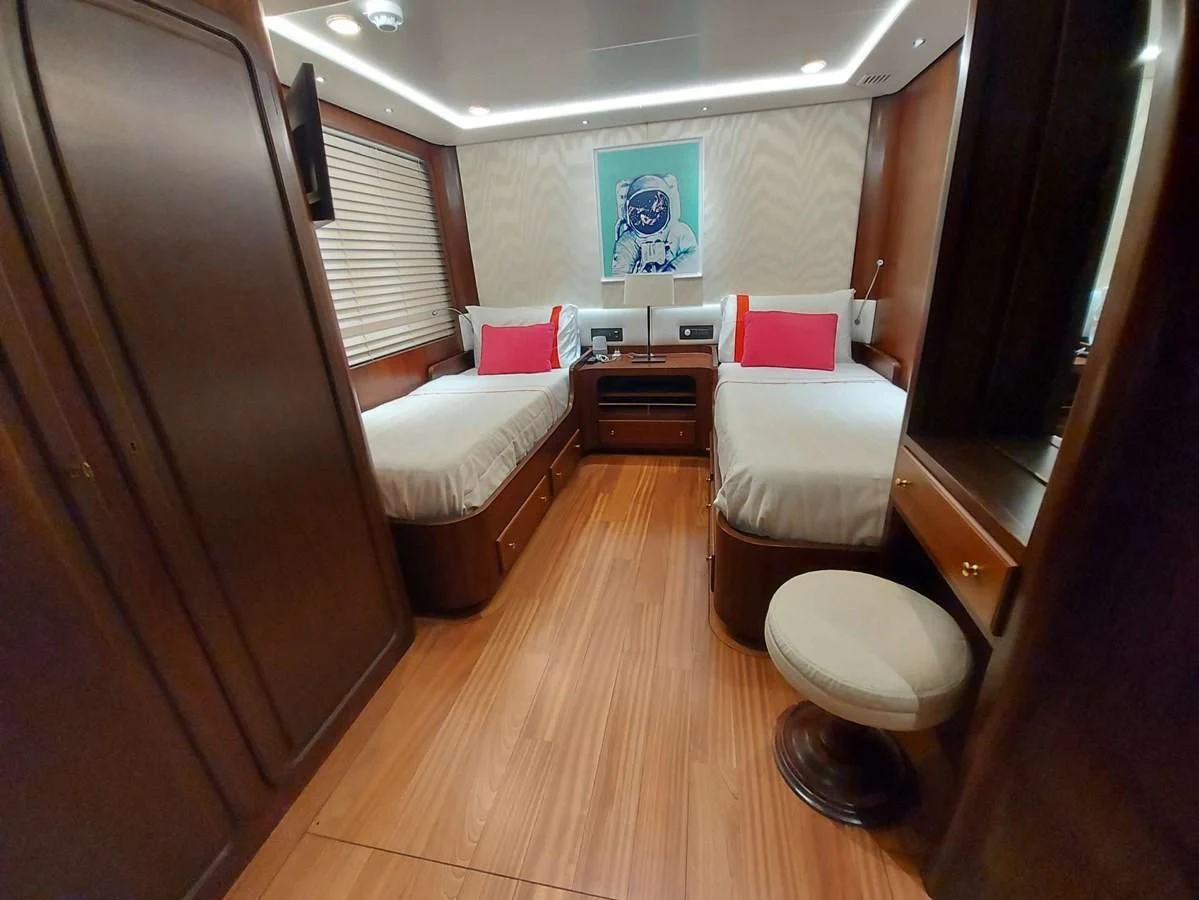 a room with a bed and a chair aboard DENEB'S DAUGHTERS Yacht for Sale