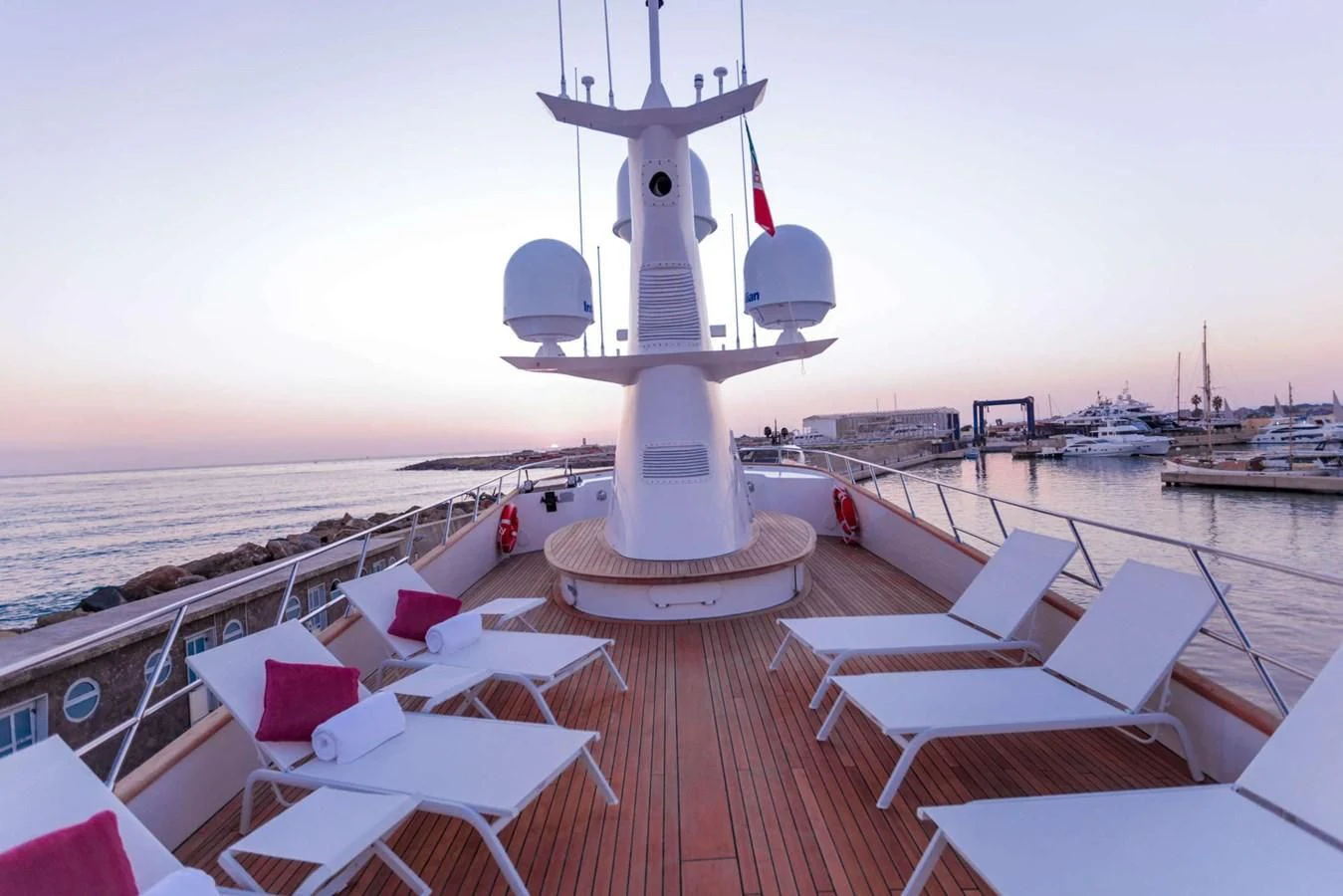 a deck with a deck and a large ship in the water aboard DENEB'S DAUGHTERS Yacht for Sale
