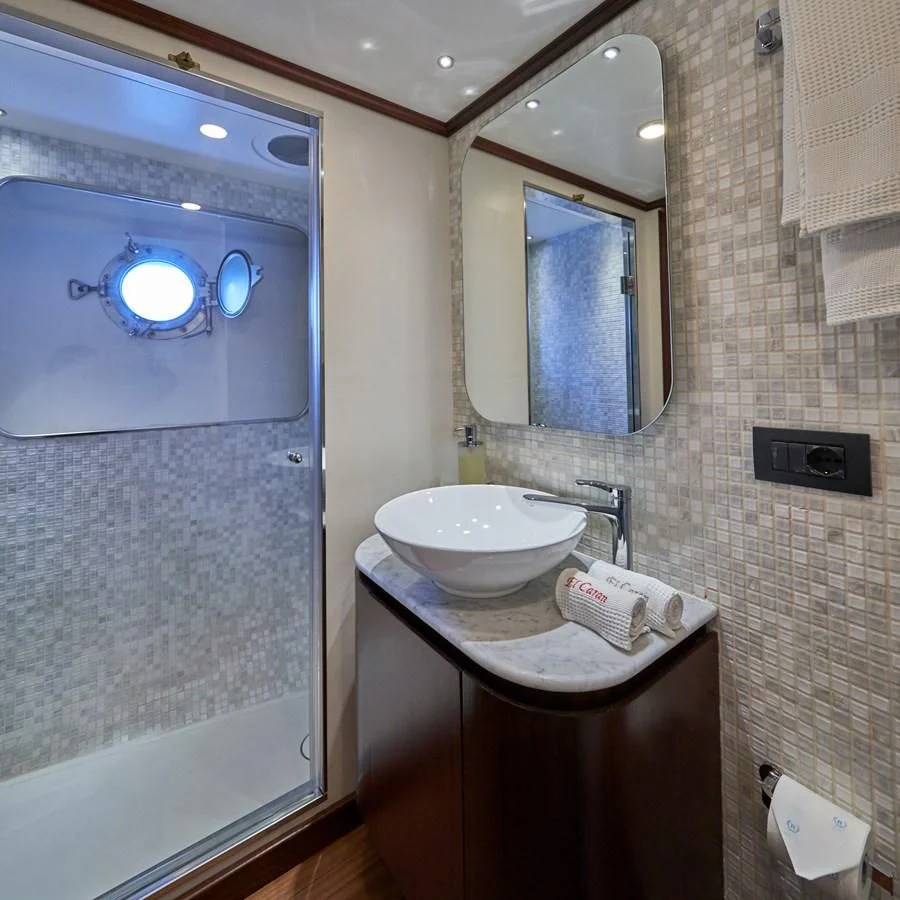 a bathroom with a sink and a mirror aboard DENEB'S DAUGHTERS Yacht for Sale