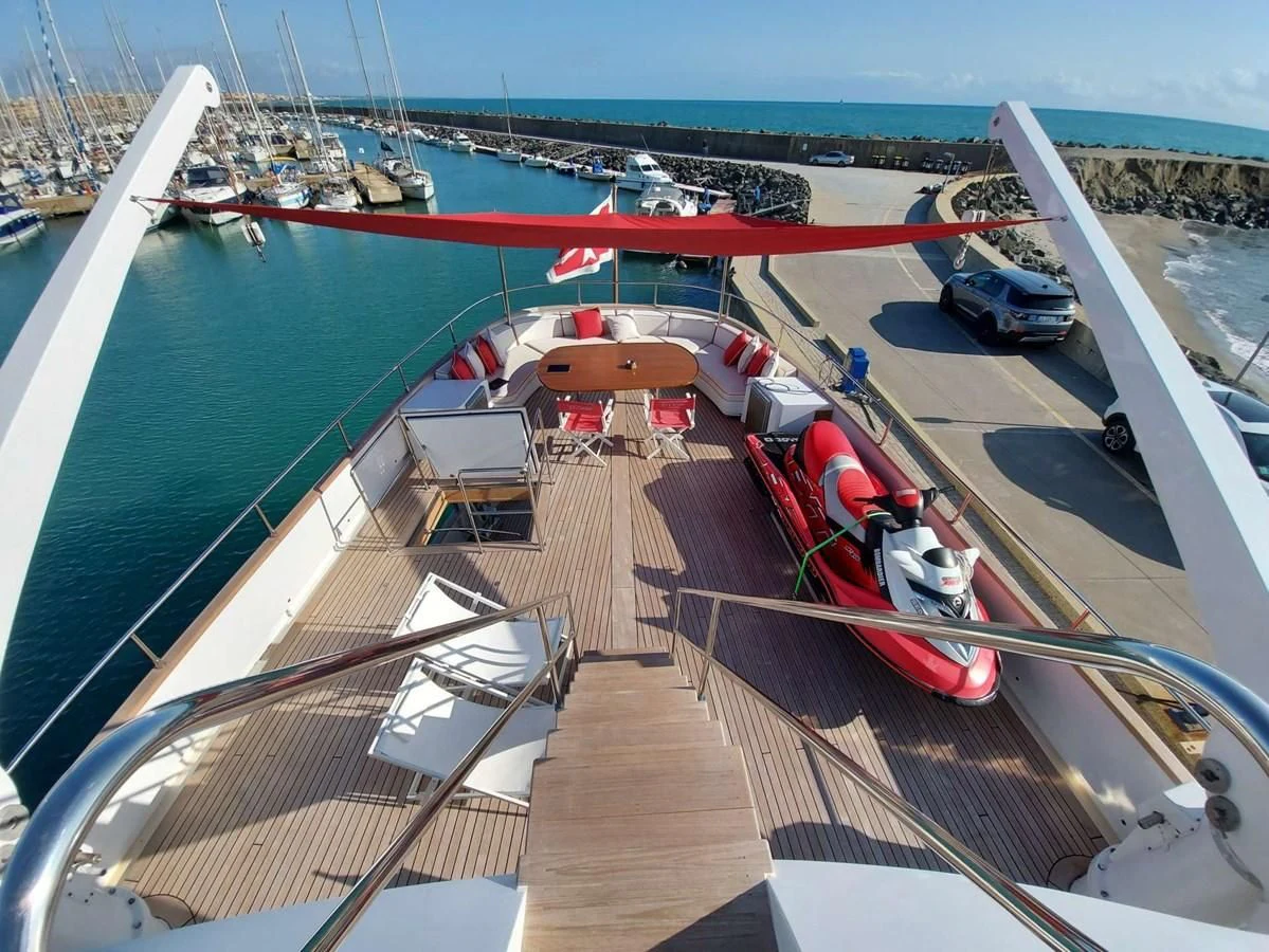 a deck with a boat and a dock aboard DENEB'S DAUGHTERS Yacht for Sale