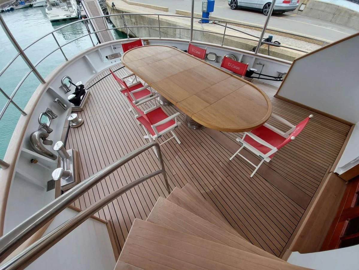 a deck with a table and chairs aboard DENEB'S DAUGHTERS Yacht for Sale