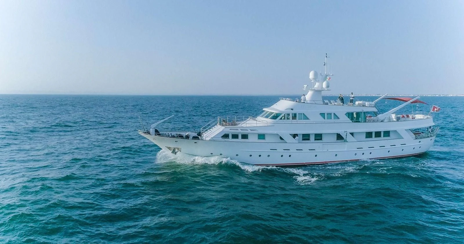 a large white boat in the water aboard DENEB'S DAUGHTERS Yacht for Sale