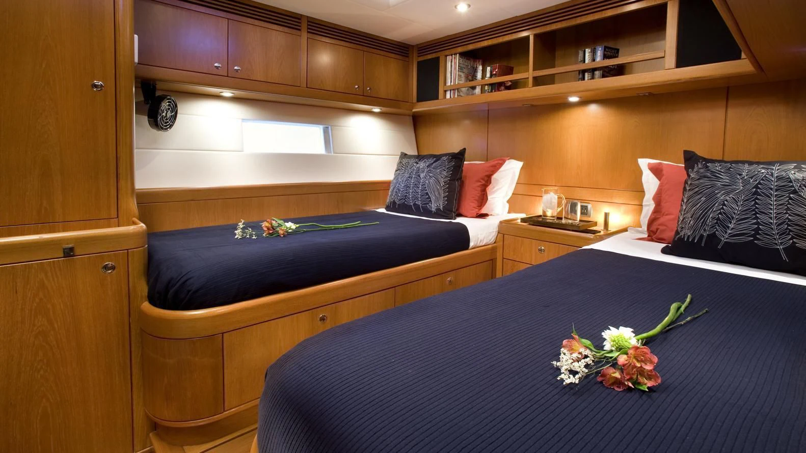 a bed with a blue sheet and pillows aboard THIRTY NINE Yacht for Sale