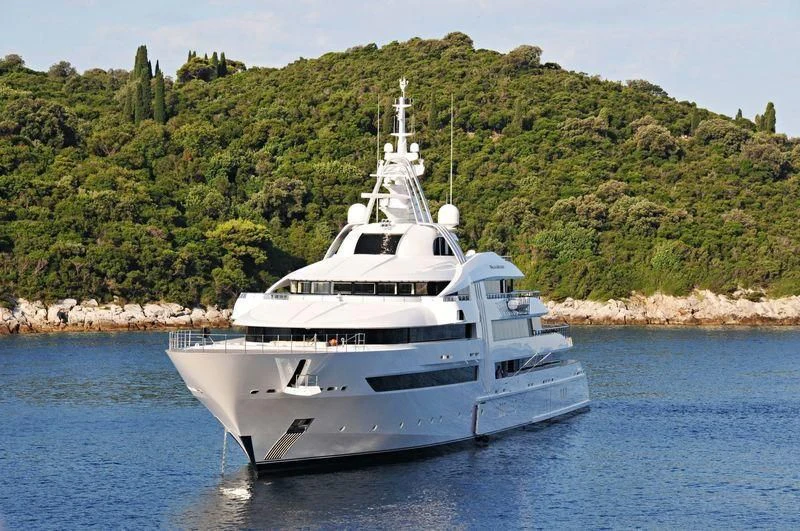 a white yacht in the water aboard VIBRANT CURIOSITY Yacht for Sale