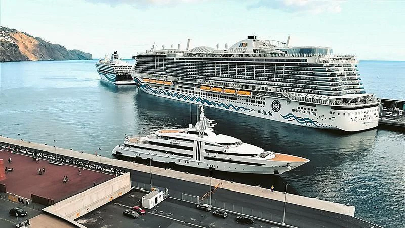a cruise ship docked at a port aboard VIBRANT CURIOSITY Yacht for Sale