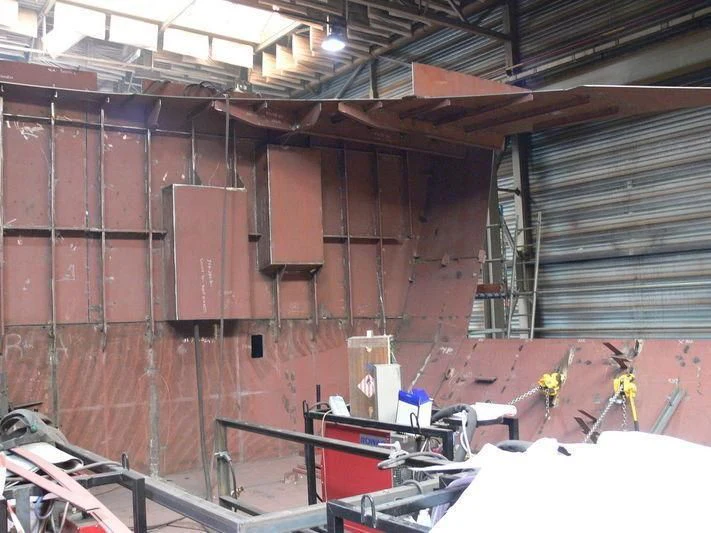 a room with a brick wall and a lot of boxes and a ladder aboard VIBRANT CURIOSITY Yacht for Sale