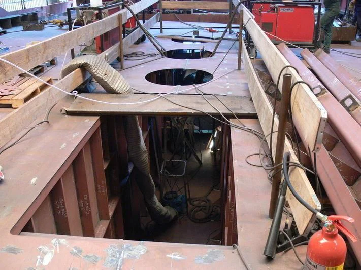 a wood table with a metal frame aboard VIBRANT CURIOSITY Yacht for Sale