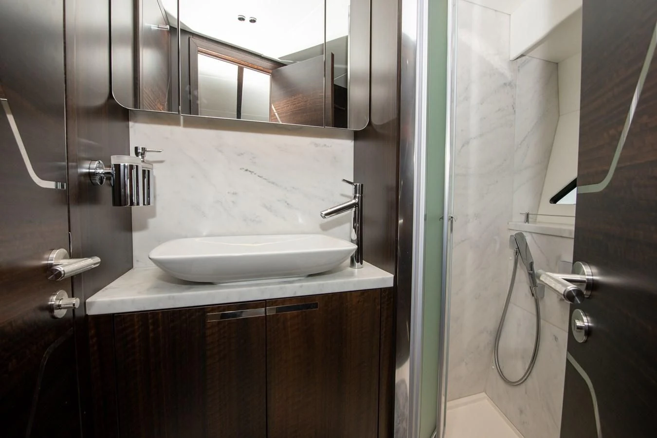 a bathroom with a sink and mirror aboard INCENTIVIZED Yacht for Sale