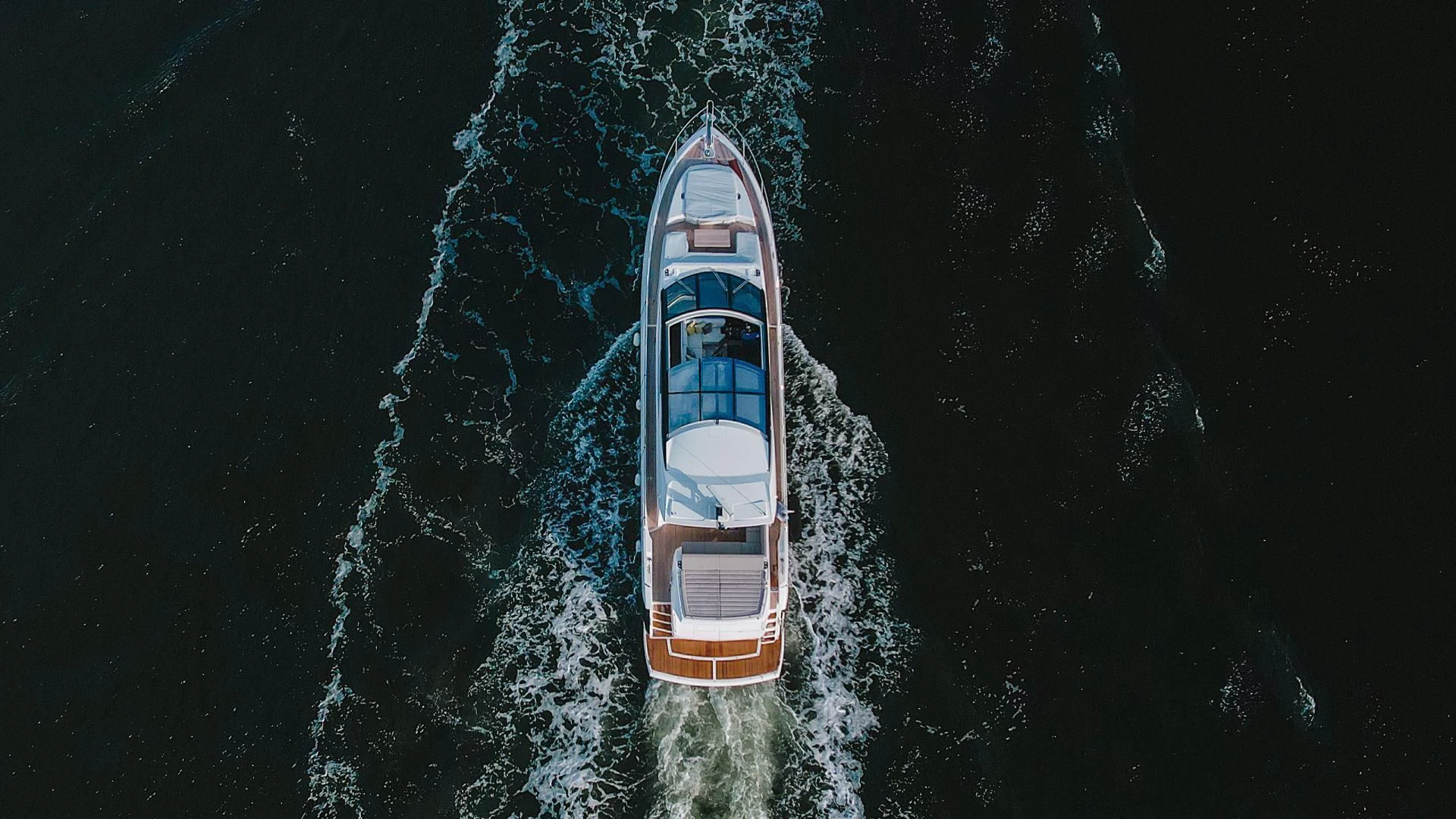 a white and orange boat in the water aboard INCENTIVIZED Yacht for Sale