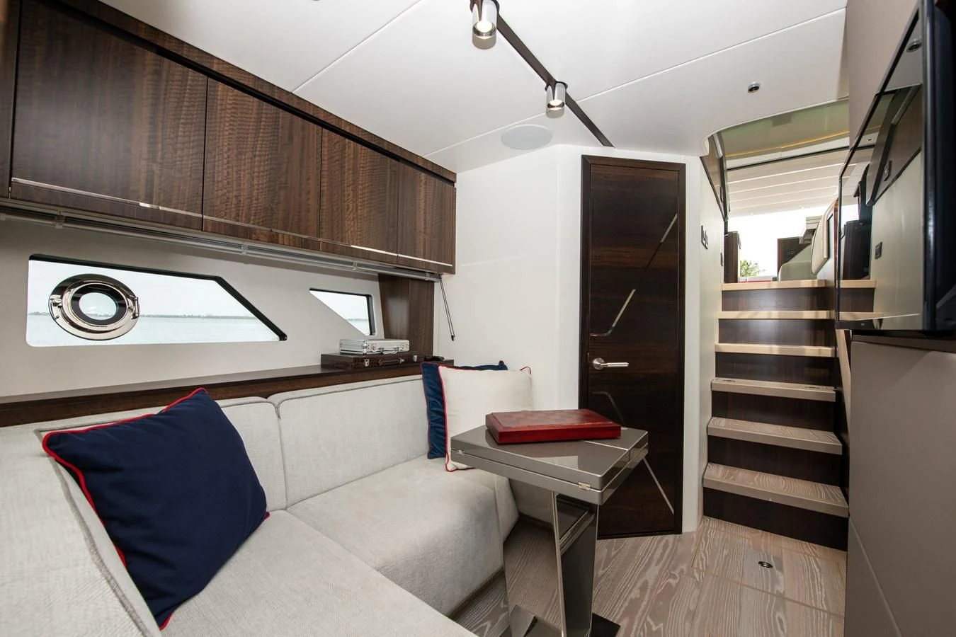 a living room with a couch and a table aboard INCENTIVIZED Yacht for Sale