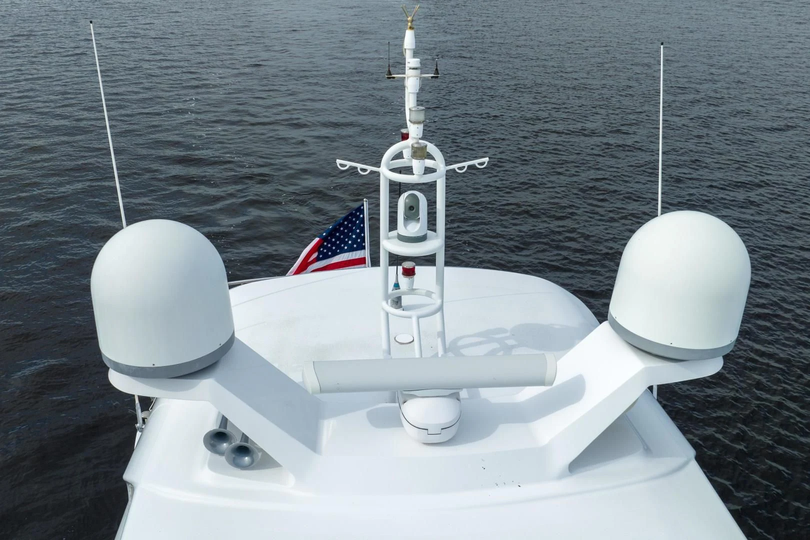 a white boat with a flag on it aboard NEVER REST Yacht for Sale