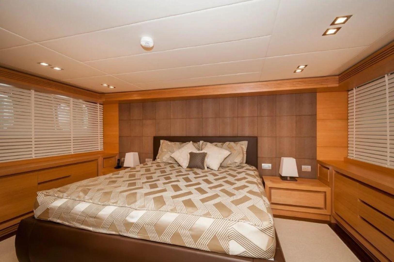 a bedroom with a bed and a desk aboard NEVER REST Yacht for Sale