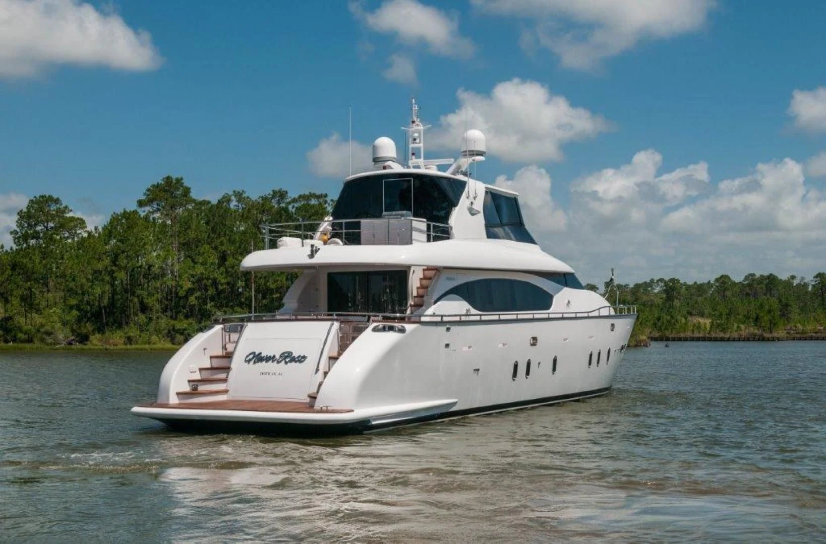 a white boat on the water aboard NEVER REST Yacht for Sale