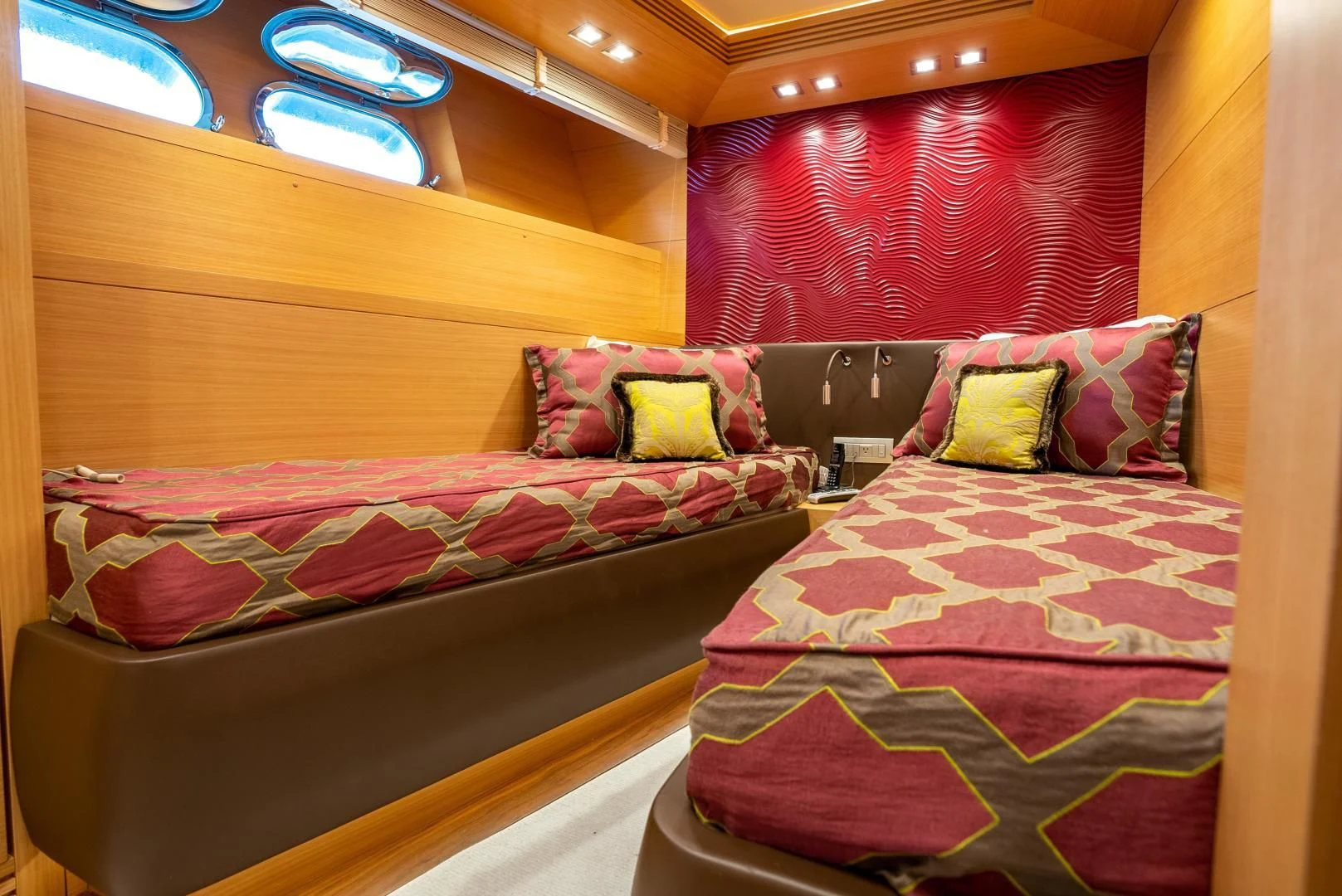 a room with beds and a window aboard NEVER REST Yacht for Sale
