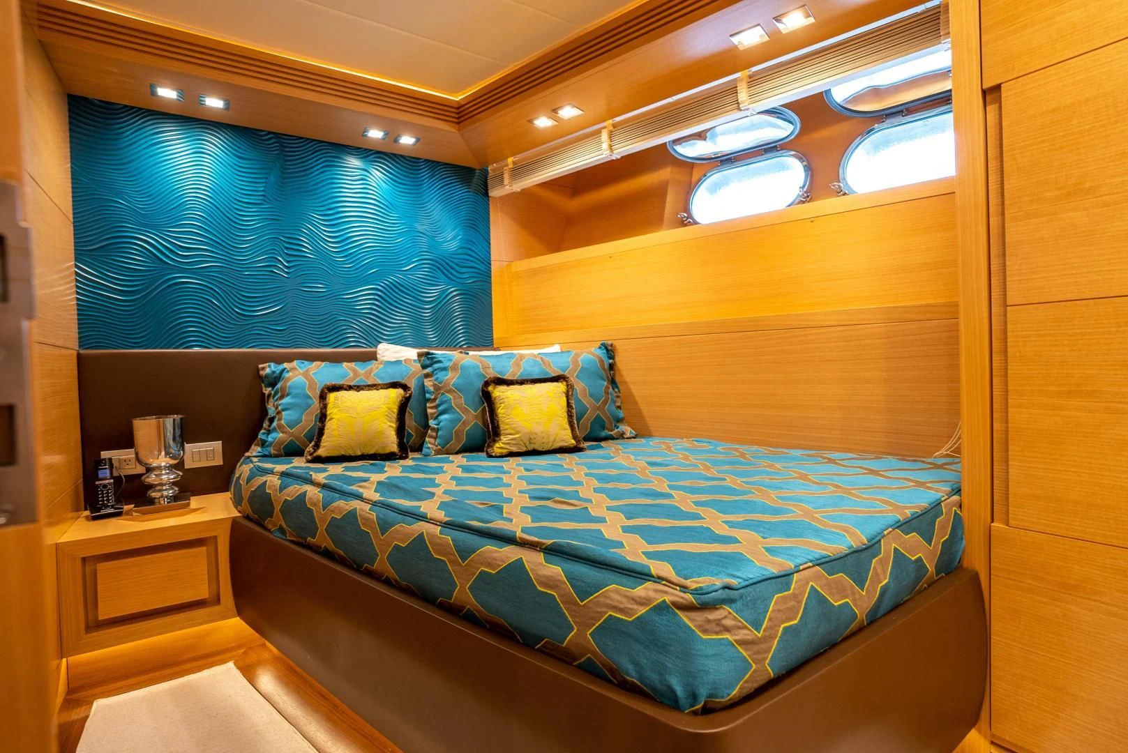 a bed with blue sheets aboard NEVER REST Yacht for Sale