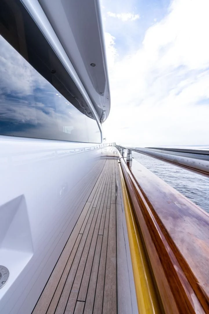 a wooden deck with a railing aboard NEVER REST Yacht for Sale