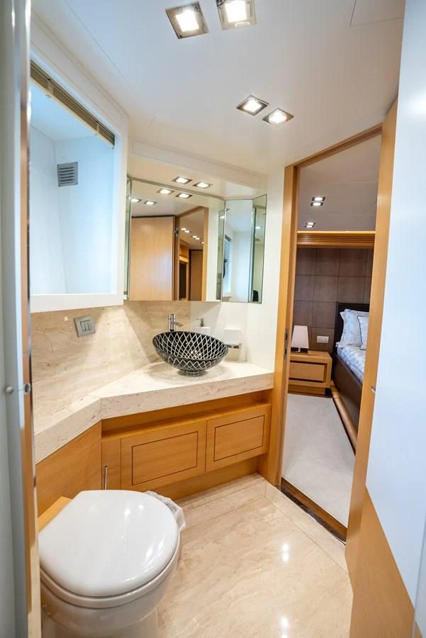 a bathroom with a toilet and a sink aboard NEVER REST Yacht for Sale