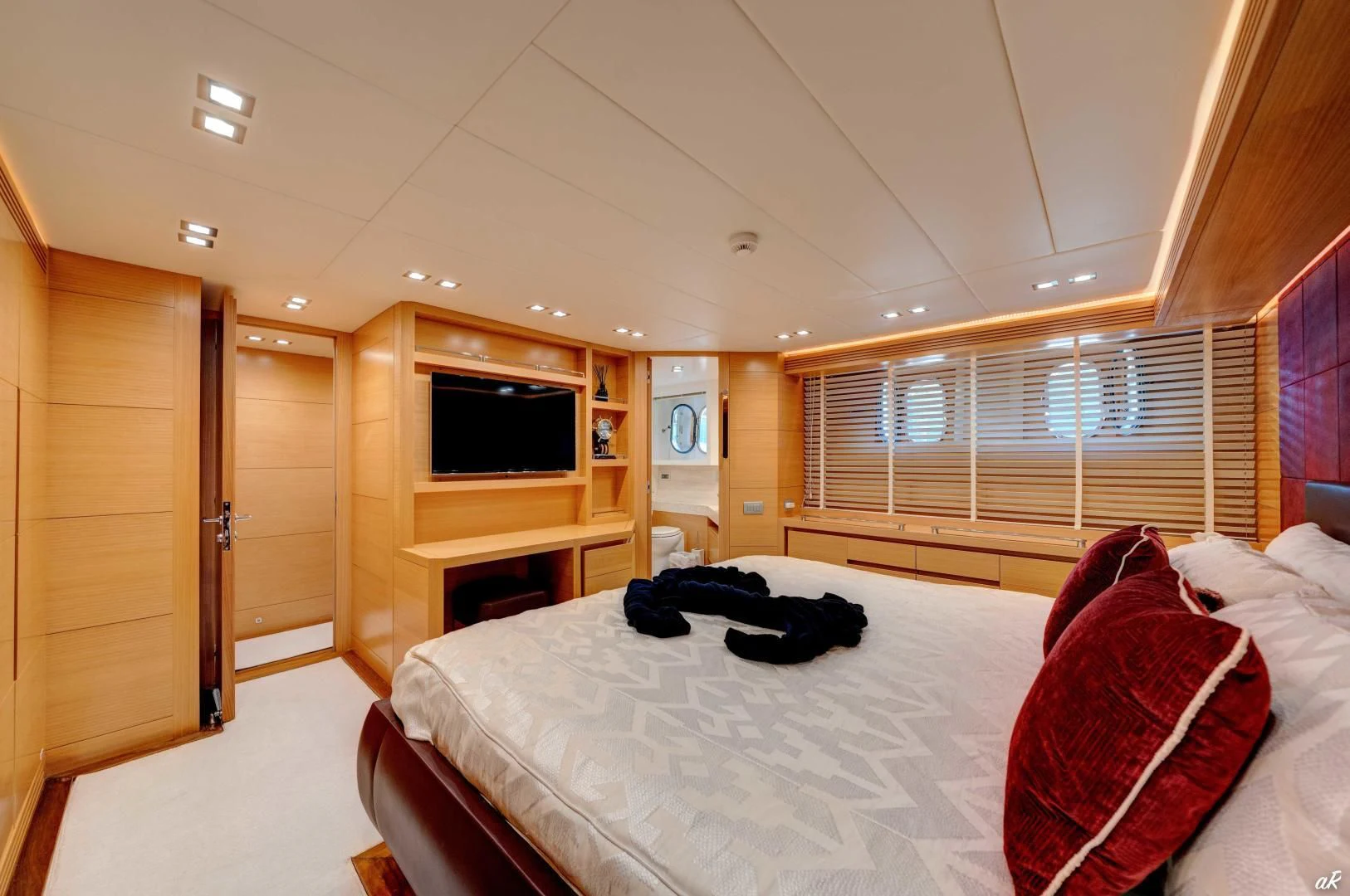 a bedroom with a bed and a television aboard NEVER REST Yacht for Sale