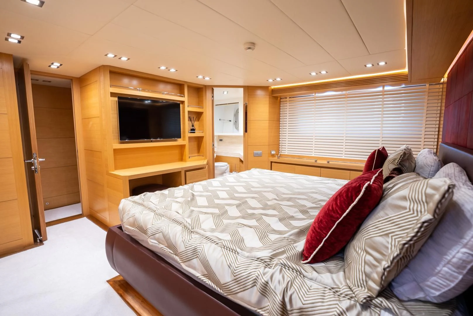 a bedroom with a bed and a television aboard NEVER REST Yacht for Sale