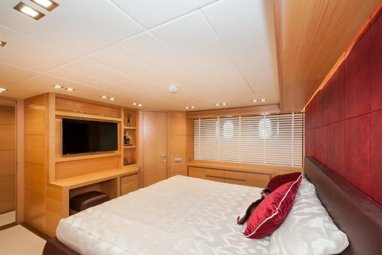 a bedroom with a bed and a tv aboard NEVER REST Yacht for Sale