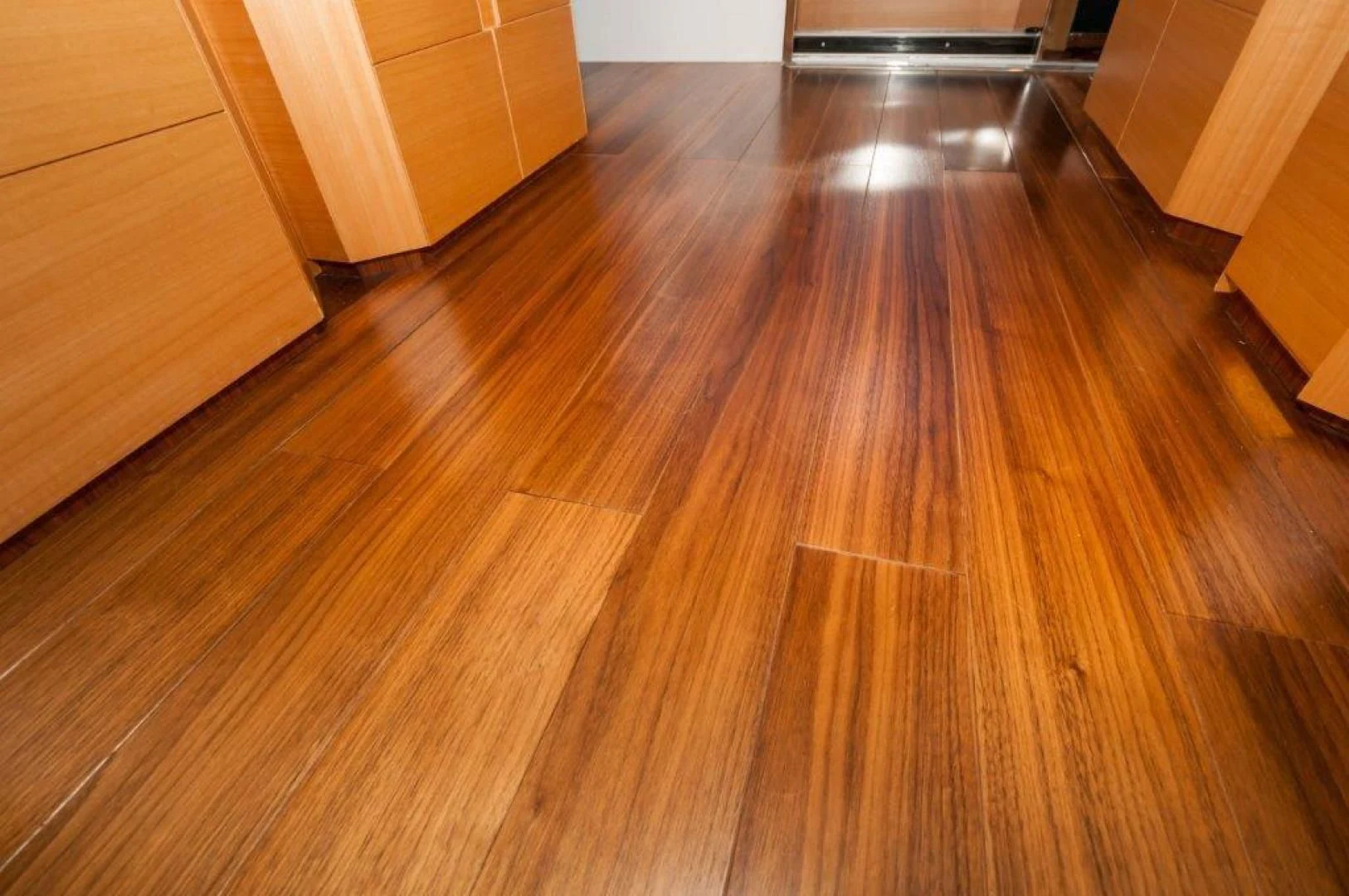 a wooden floor with a light shining on it aboard NEVER REST Yacht for Sale
