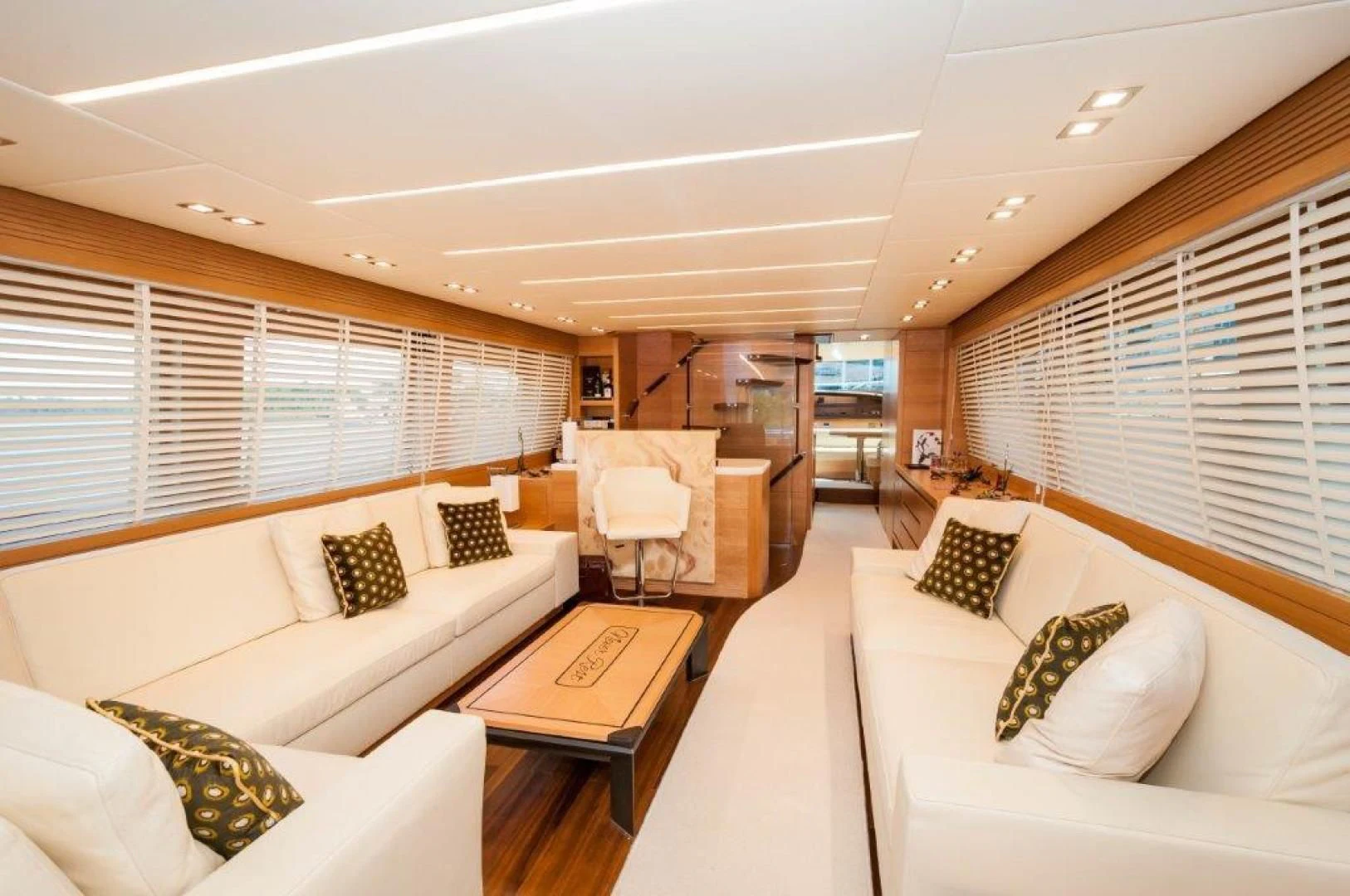 a living room with a couch and a table aboard NEVER REST Yacht for Sale