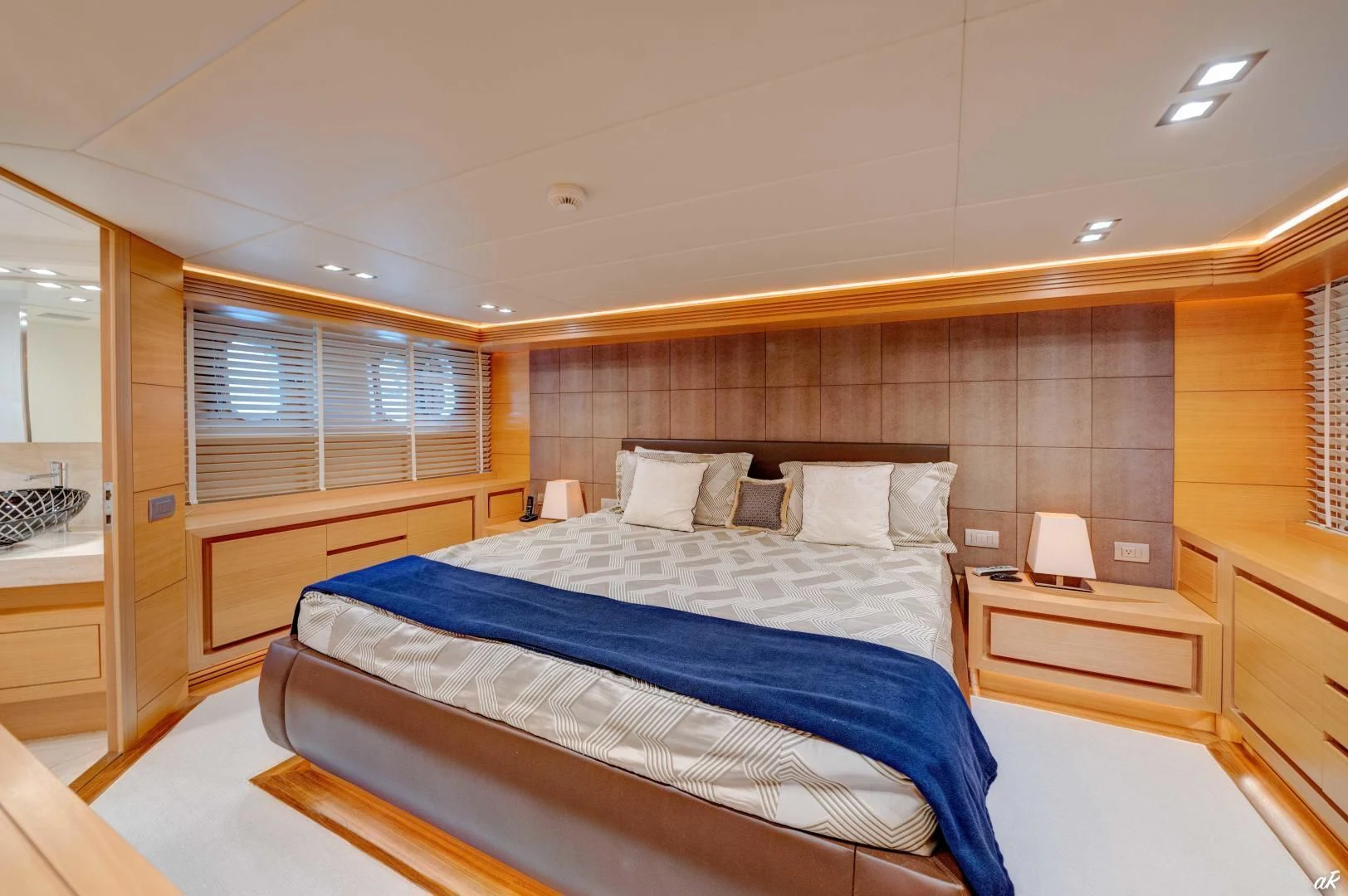 a bedroom with a bed and a window aboard NEVER REST Yacht for Sale
