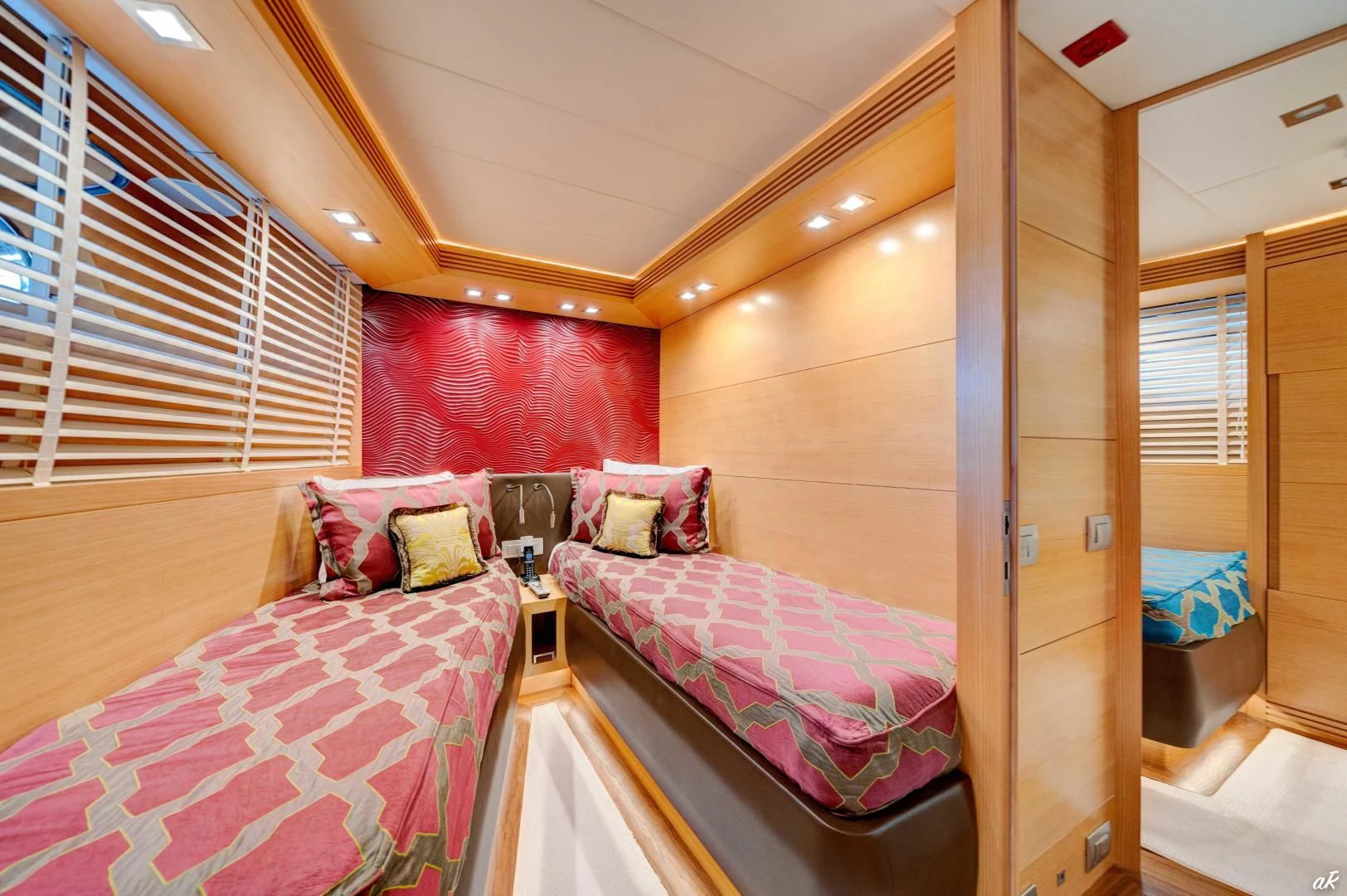 a bedroom with a bed and a chair aboard NEVER REST Yacht for Sale
