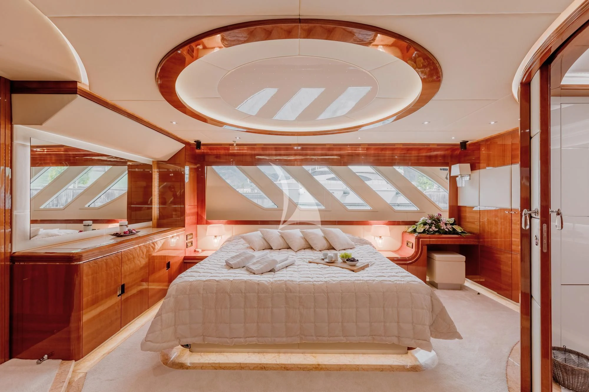 a bedroom with a bed and a mirror aboard LADY MURA Yacht for Sale