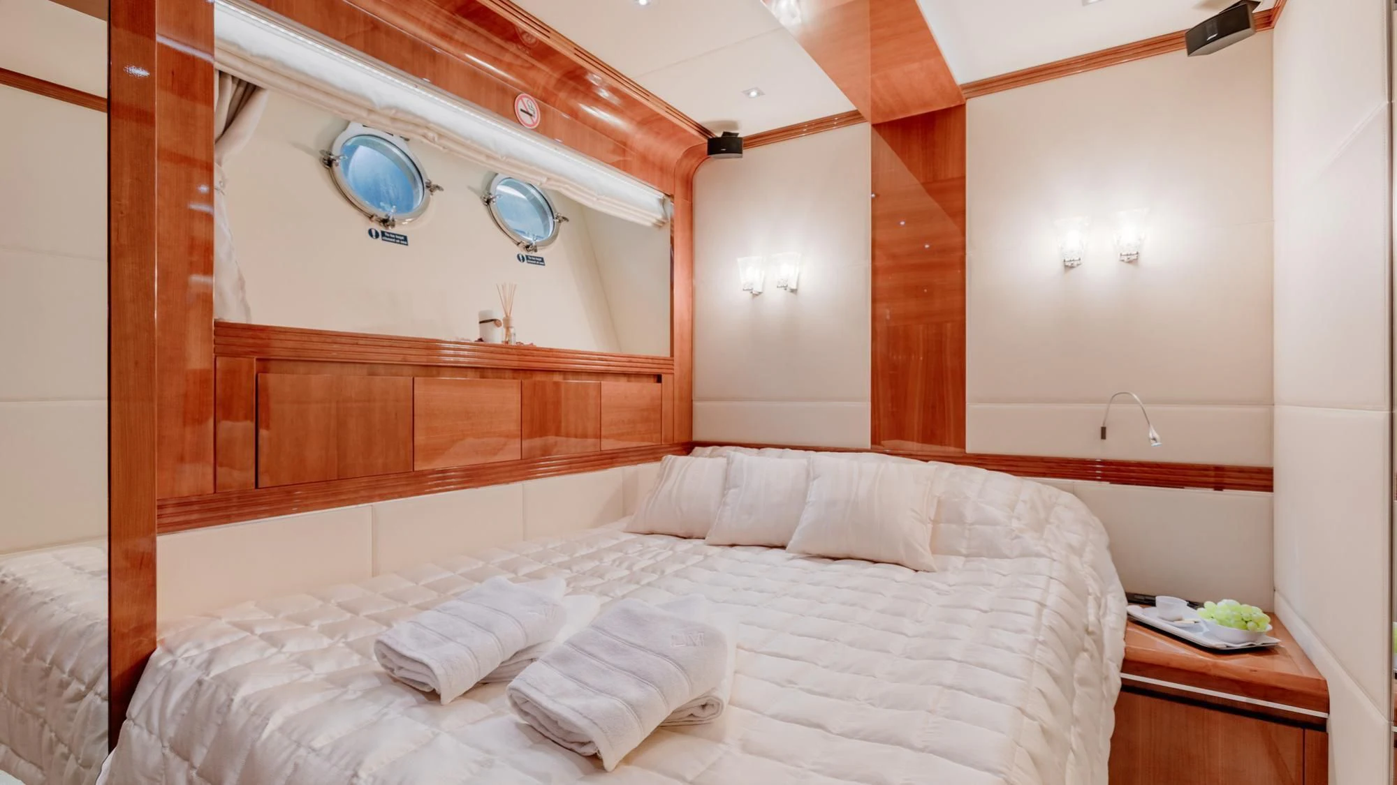 a bed with white sheets aboard LADY MURA Yacht for Sale