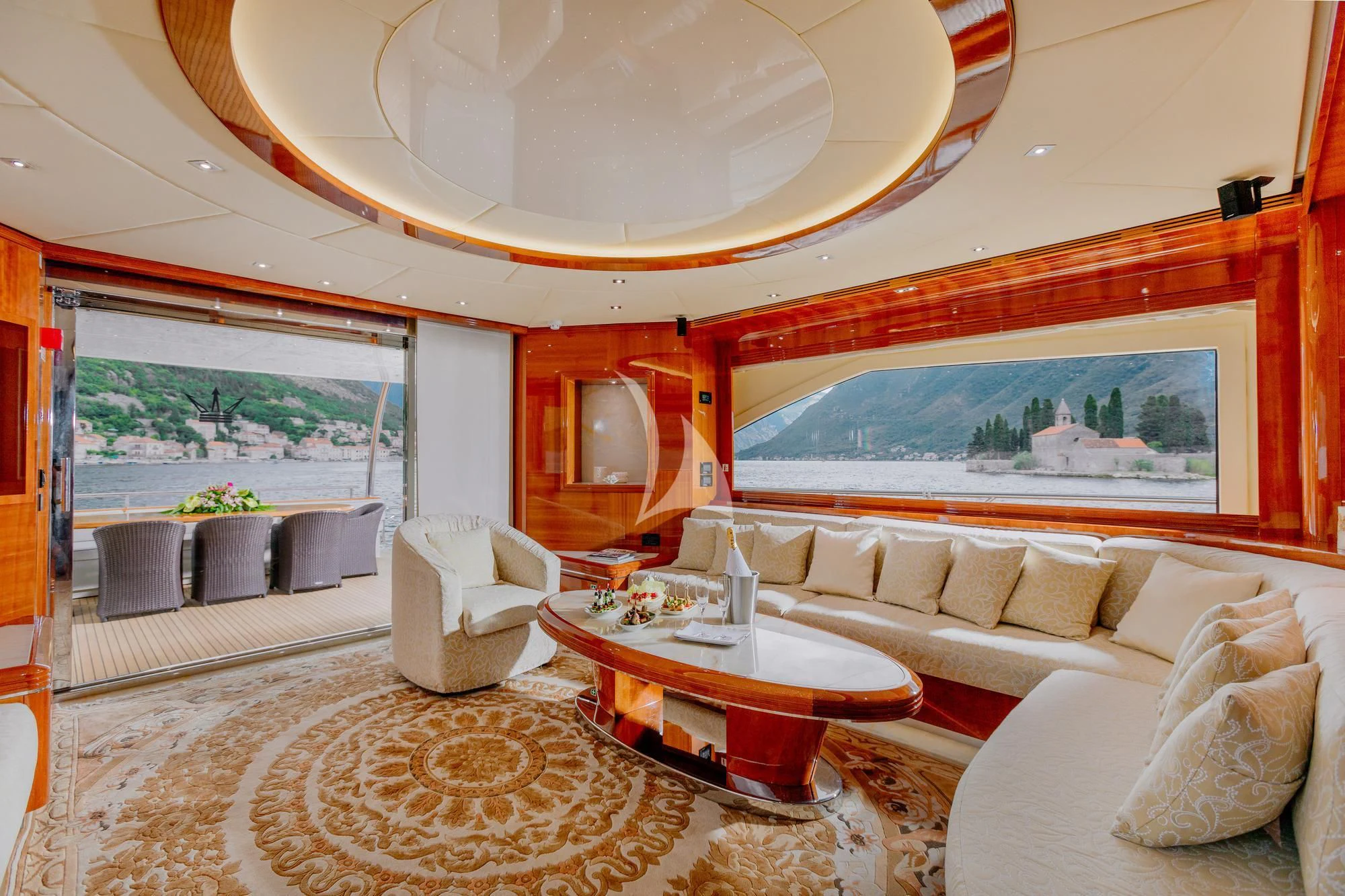 a living room with a large mirror aboard LADY MURA Yacht for Sale