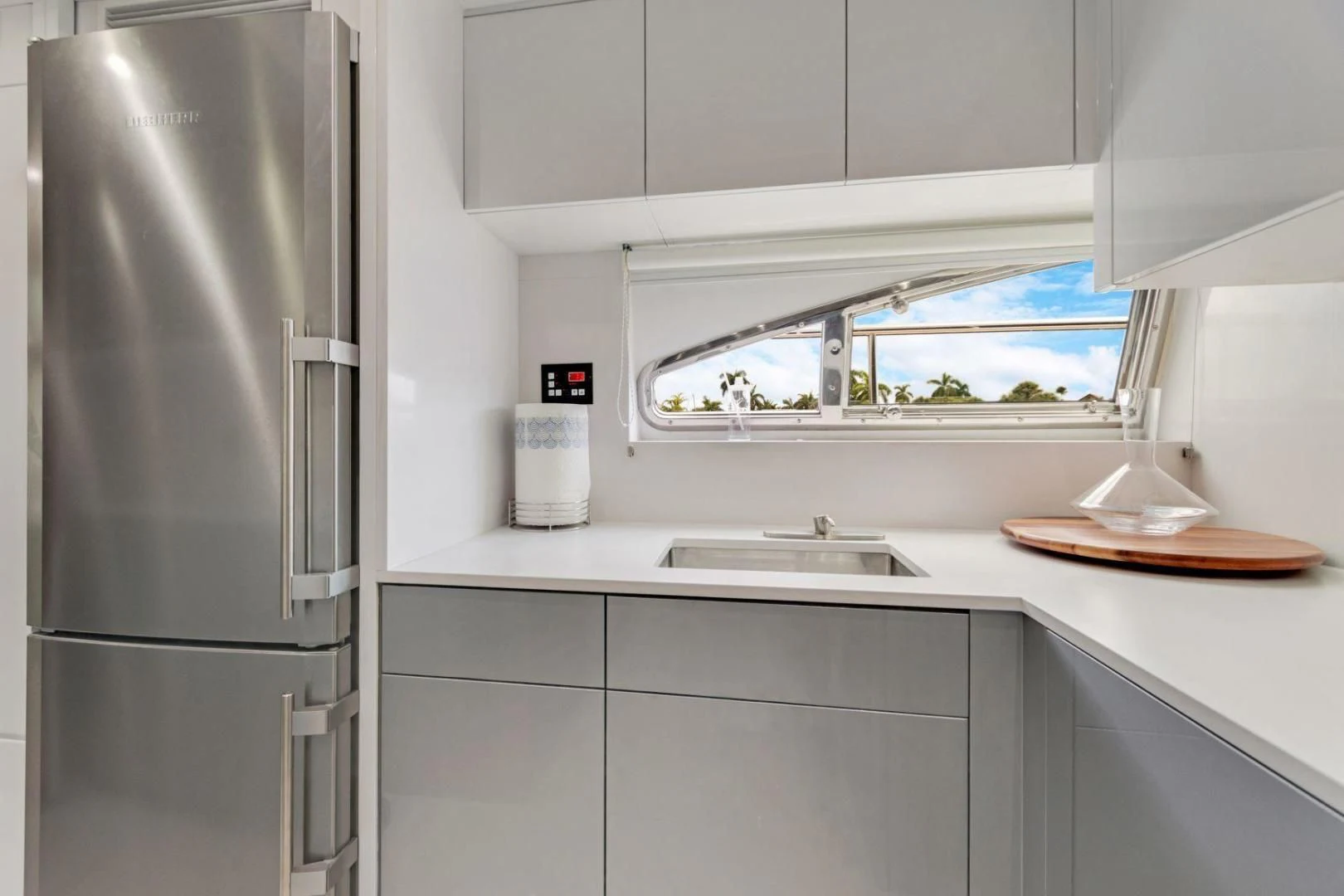 a kitchen with a refrigerator and sink aboard SINPATICO Yacht for Sale