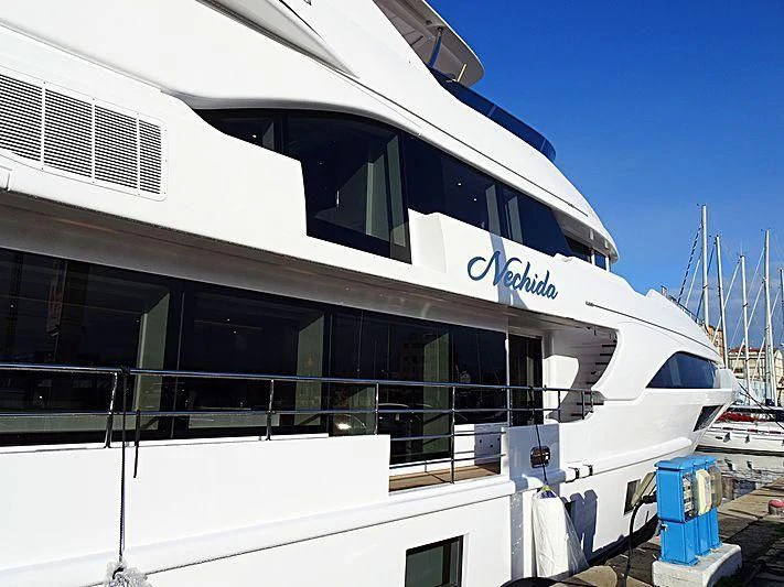 a white building with a black and silver exterior aboard NECHIDA Yacht for Sale