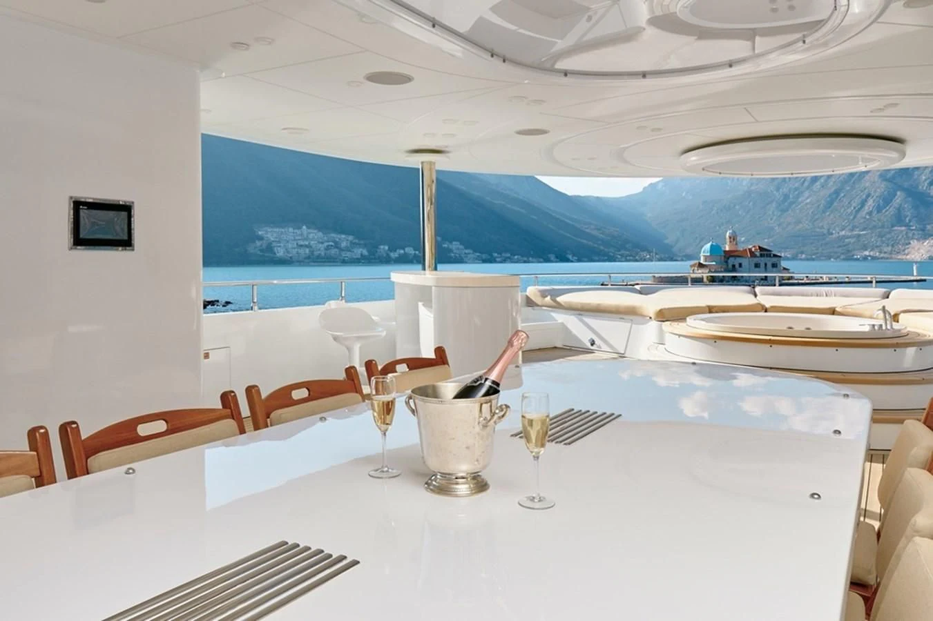 a table with glasses and a view of the ocean aboard VERA Yacht for Sale