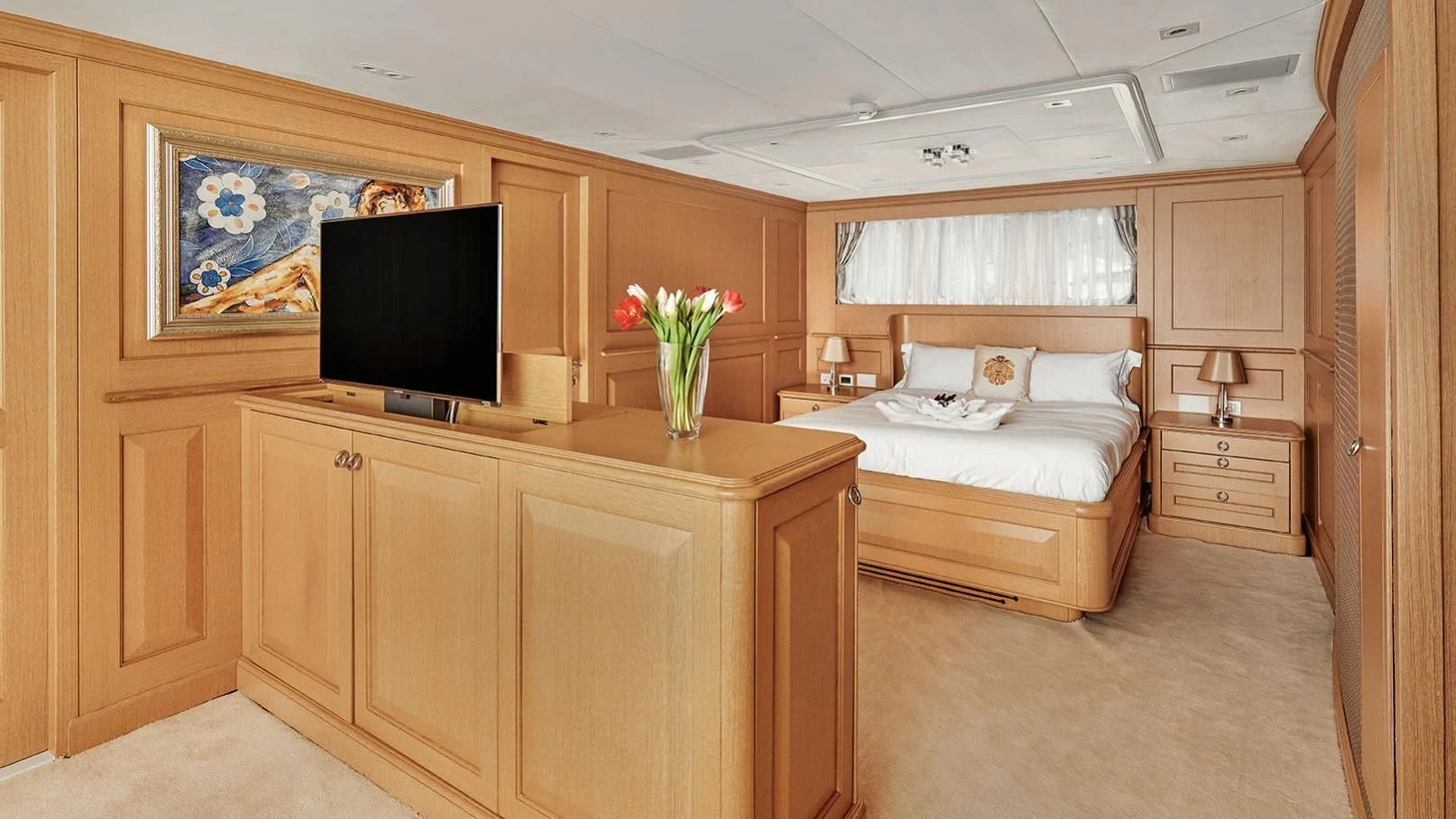 a bedroom with a bed and a tv aboard VERA Yacht for Sale