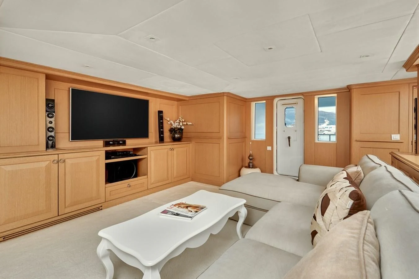 a living room with a tv and furniture aboard VERA Yacht for Sale