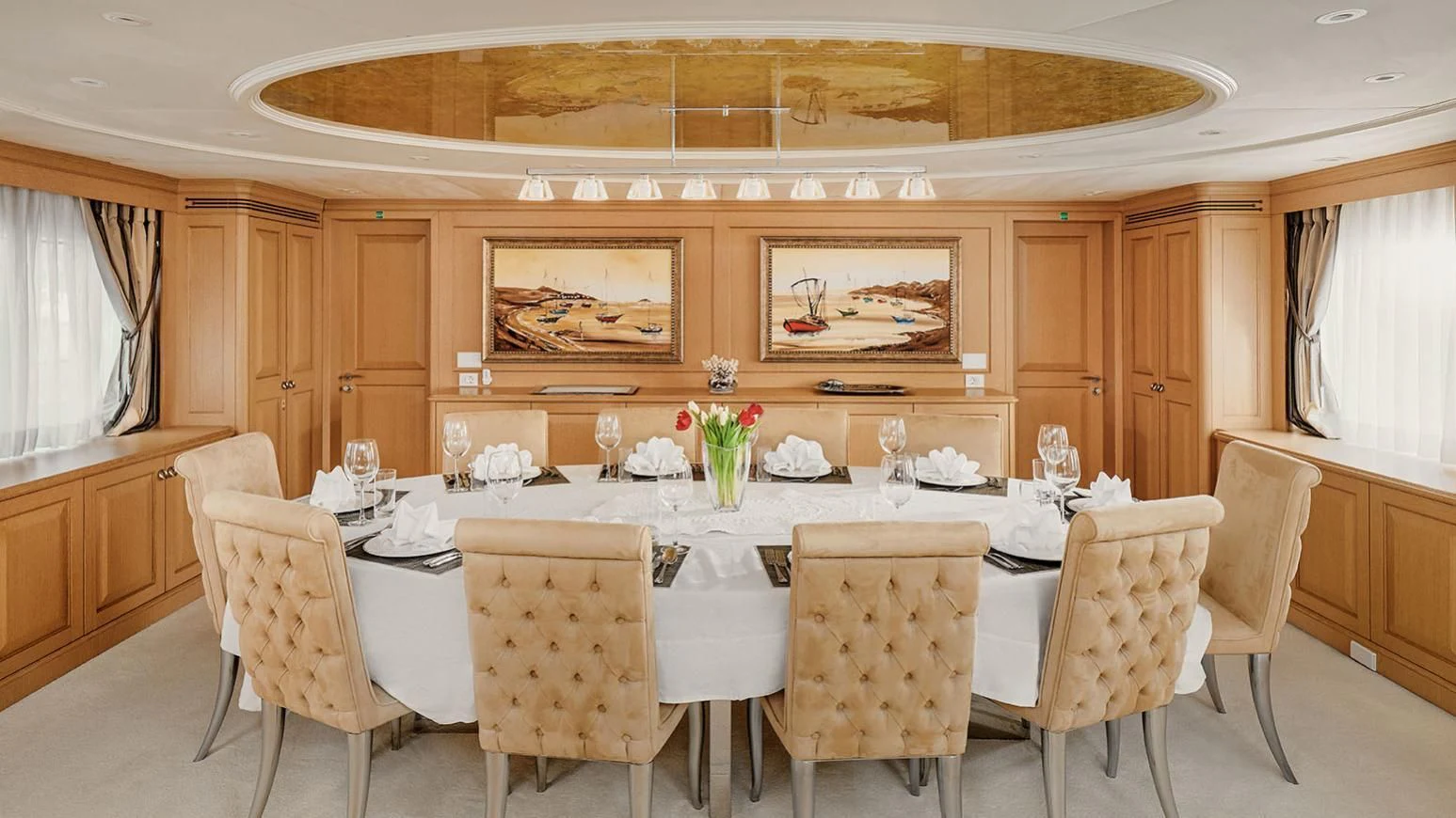 a dining table with chairs and a large window aboard VERA Yacht for Sale
