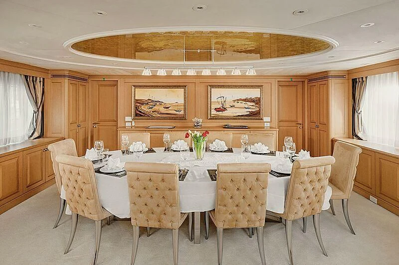 a dining table with chairs aboard VERA Yacht for Sale