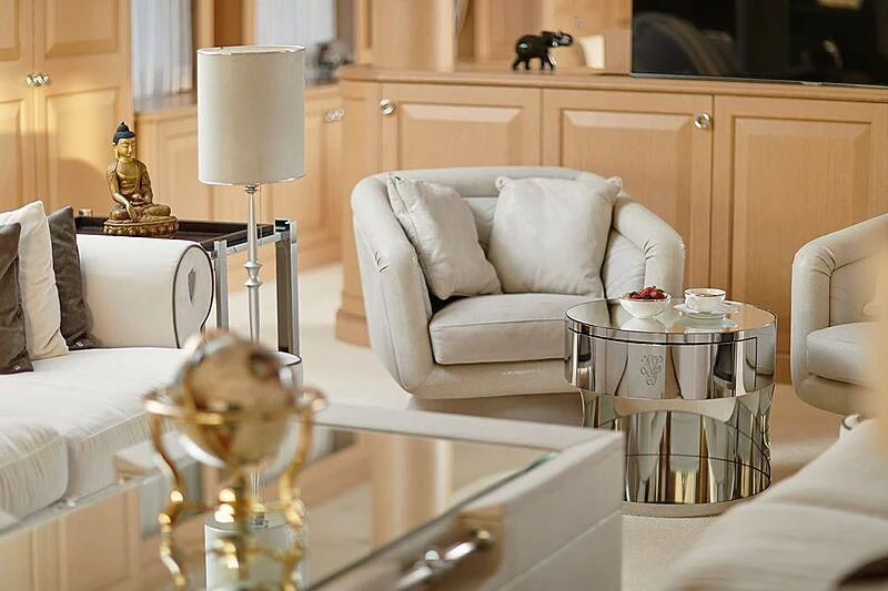 a living room with a glass coffee table and a white couch aboard VERA Yacht for Sale